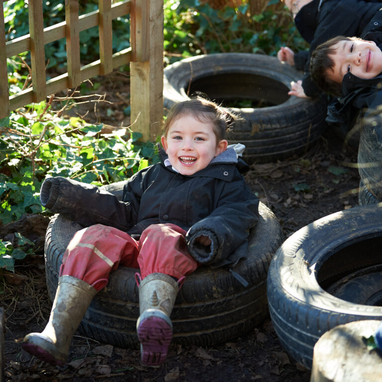 girl sat in a tyre