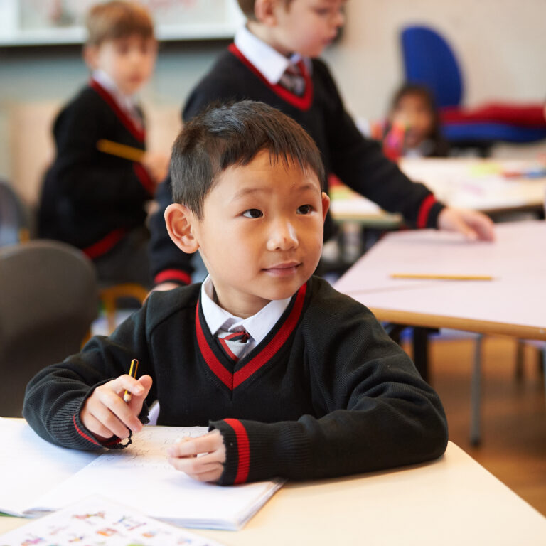 young boy holding a pencil