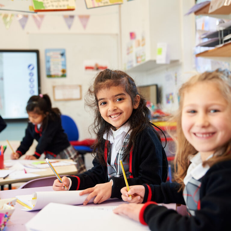 girls sat at their desks in the classroom