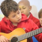 Student playing guitar