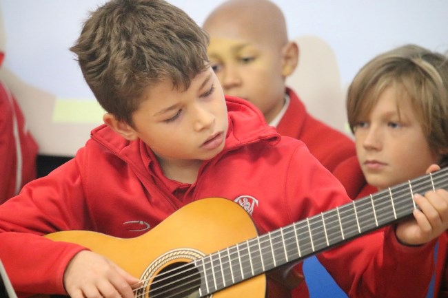 Student playing guitar