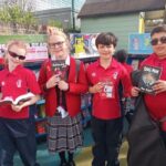 Students holding up books