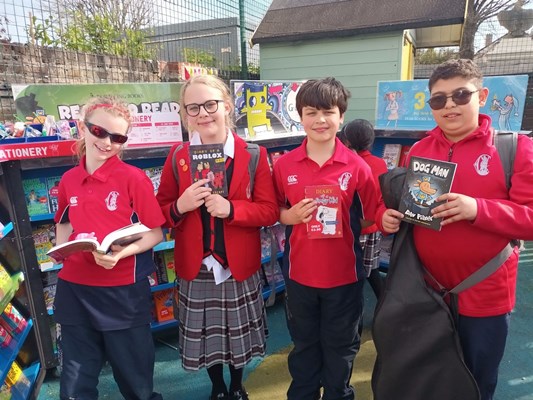 Students holding up books