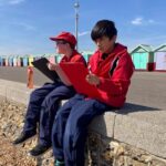 Students sat on the beach