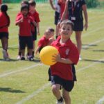 Boy holding a yellow ball