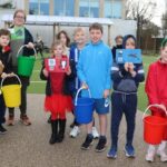 students holding colourful buckets