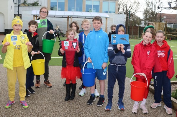 students holding colourful buckets