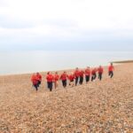 students running on the beach