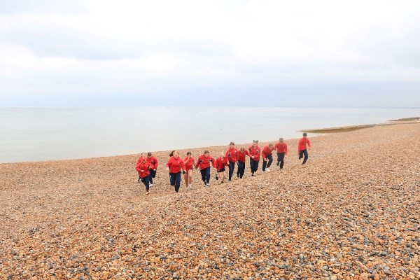 students running on the beach